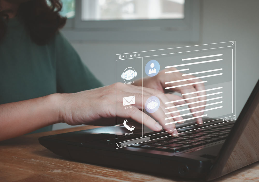 laptop with graphic pop up and woman's hands on the keyboard